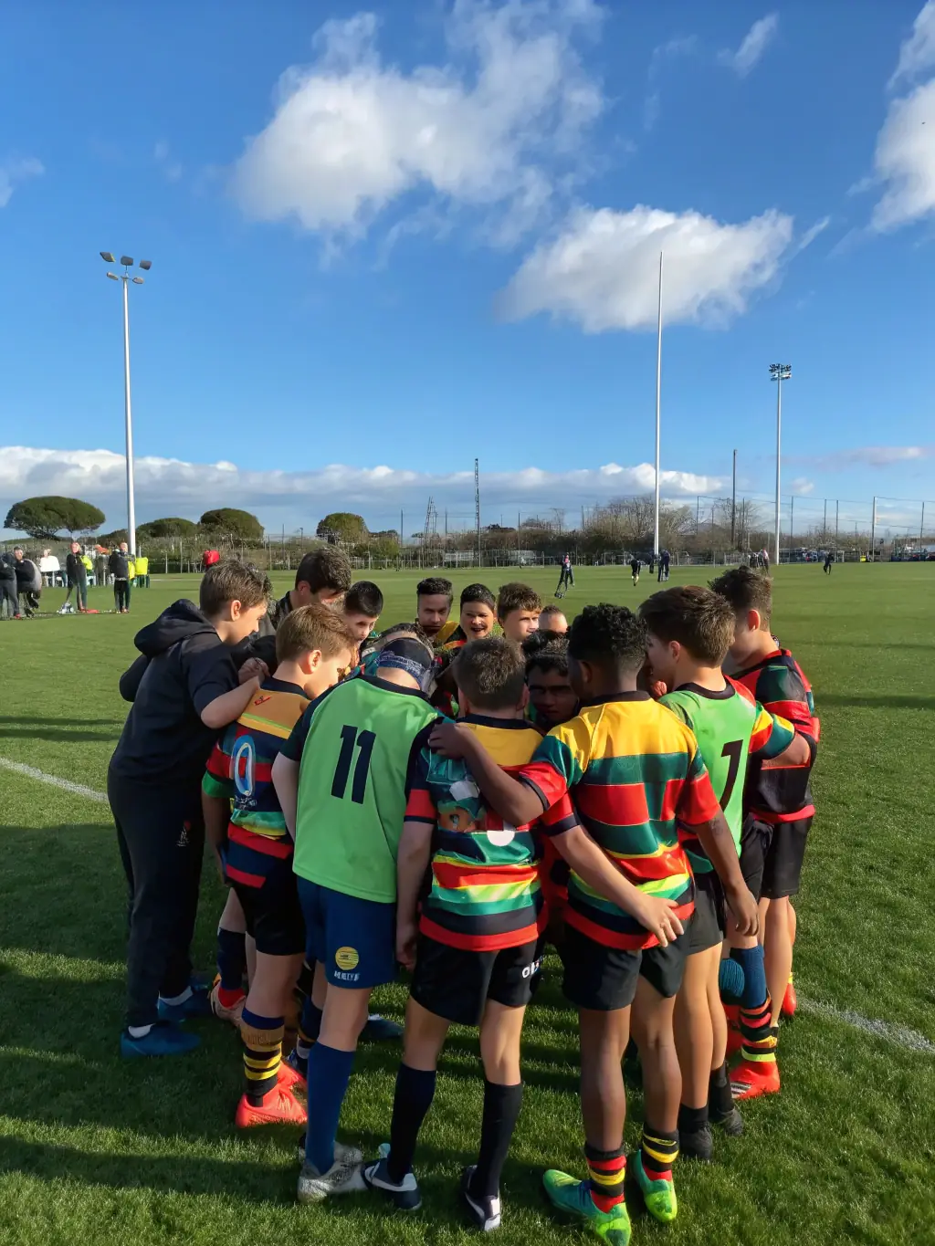 A vibrant image capturing young rugby players participating in a training session organized by LES GABARIANS, focusing on teamwork and skill development.